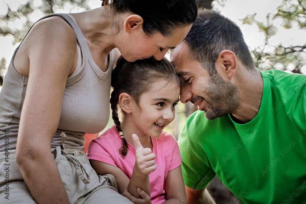 Fototapeta premium Happy family bonding moment in nature with smiling child showing thumbs up