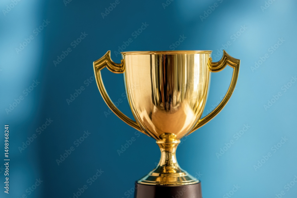 Golden trophy cup with ribbon symbolizing victory and achievement Golden trophy cup with ribbon symbolizing victory and achievement