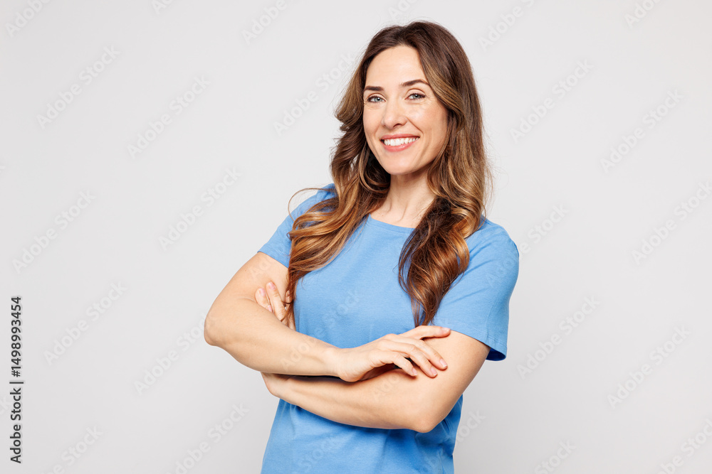 Fototapeta premium Side profile view young fun Caucasian woman wears blue t-shirt casual clothes hold hands crossed folded look camera isolated on plain solid white color background studio portrait. Lifestyle concept.