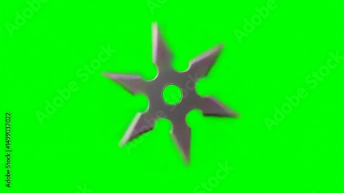 Spinning ninja shuriken on green screen background, generative ai