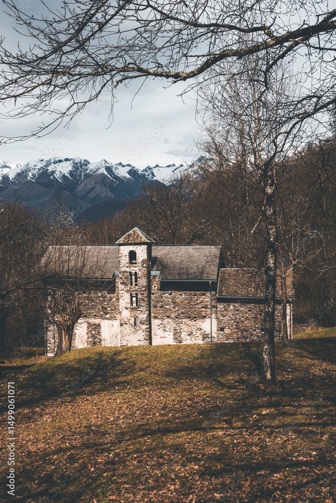 old medieval church in the wood near the mountains with snowy peaks old medieval church in the wood near the mountains with snowy peaks