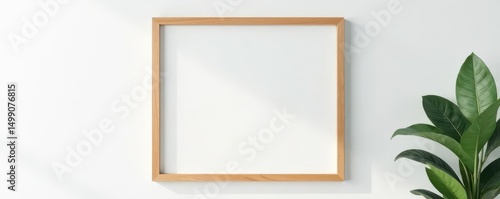 Simple wooden frame hangs on clean white wall, light, wooden, art