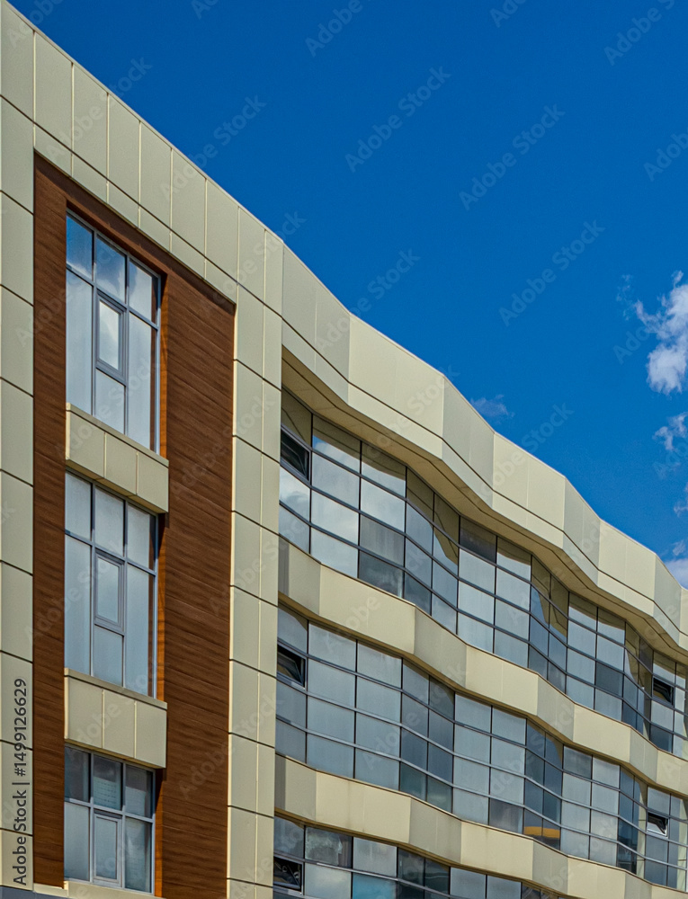 Obraz premium modern office building with blue sky and windows