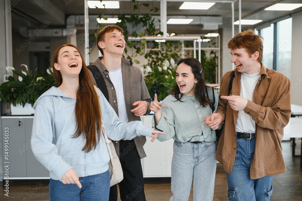 Obraz premium Happy students laughing together in university hallway