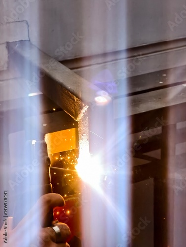 Sparks Fly During Welding Process with Bright Light and Glistening Particles in Industrial Setting