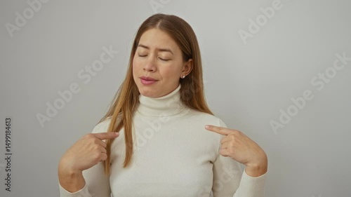 Wallpaper Mural Woman with brown hair in a white turtleneck gestures pointing to herself and shaking her finger against an isolated white background, expressing self-denial and emphasis. Torontodigital.ca