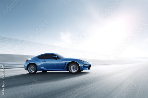 sleek sports car racing on track with clear blue sky in background