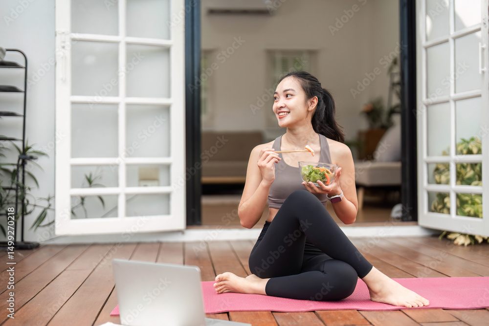 Healthy Eating and Yoga. Young woman enjoying a nutritious salad after yoga session. Healthy Eating and Yoga. Young woman enjoying a nutritious salad after yoga session.