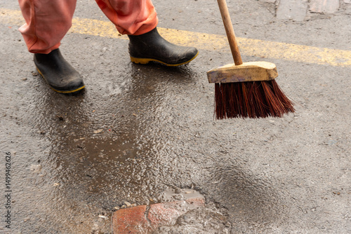 Wallpaper Mural Cleaning worker cleaning the floor of a street. Concept of public hygiene and care. Torontodigital.ca
