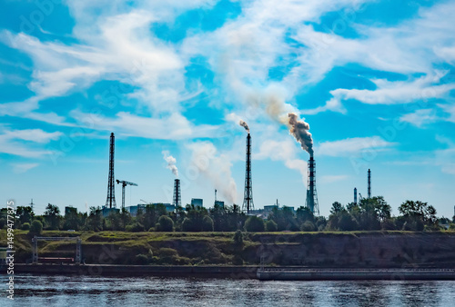 Chemurgy. Plant for the production of chemical fertilizers on the banks of the river. Lots of smoking stack-furnaces and chaotic sky smoke