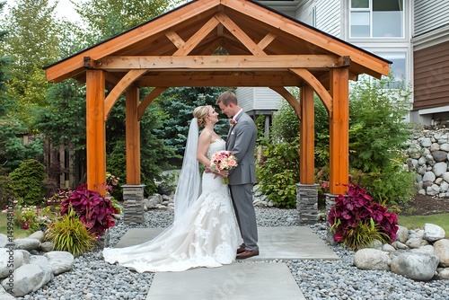 Newlyweds Under a Wooden Gazebo