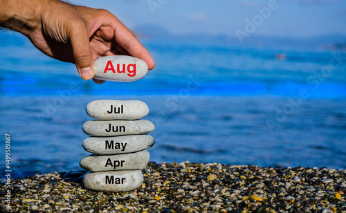 A hand places a stone labeled 