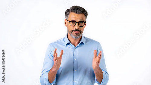 Middle aged man with grey hair and glasses gesturing with hands isolated on white background looking at the camera in a studio setting