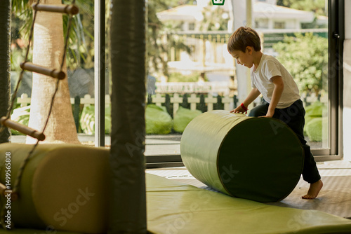 Little boy plating in the indoor kids club.