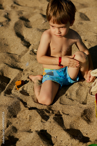 little boy playing on the beach