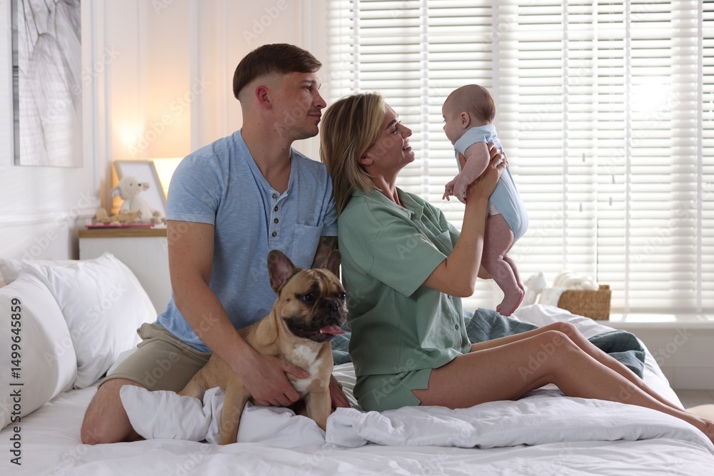Happy family with little baby and cute dog on bed at home Happy family with little baby and cute dog on bed at home