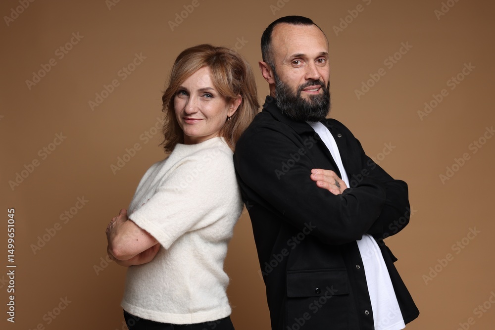 Portrait of lovely couple on brown background Portrait of lovely couple on brown background