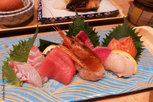 close up of assorted Japanese sashimi seafood sushi fish including raw shrimp, salmon, tuna, scallop and Croaker