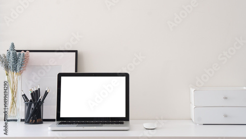 Wallpaper Mural Simple home office with blank photo frame, stationery  and laptop with blank screen for displaying mockups. Torontodigital.ca