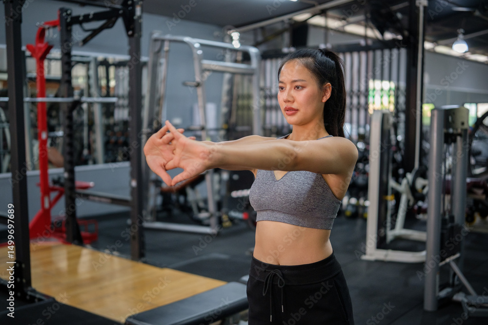 Female fitness enthusiast doing warm up stretches before workout. Female fitness enthusiast doing warm up stretches before workout.