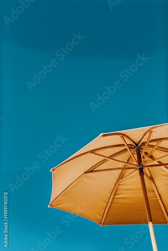 Sunny Beach Umbrella Against a Clear Blue Sky During the Warm Afternoon