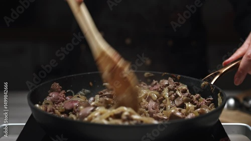 Frying Chicken Liver with Onions in Hot Skillet.
