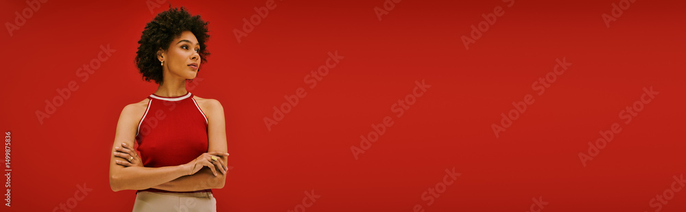Sophisticated young woman showing confidence in stylish outfit against vibrant red background Sophisticated young woman showing confidence in stylish outfit against vibrant red background