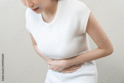 Wallpaper Mural Flatulence asian young woman intolerance hand in stomach ache, suffer from food poisoning, abdominal pain and colon problem, gastritis or diarrhoea when at home. Patient belly, abdomen or inflammation Torontodigital.ca