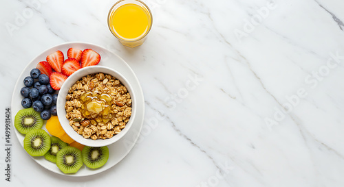 Nutritious breakfast ensemble featuring granola, fresh fruit, and invigorating juice