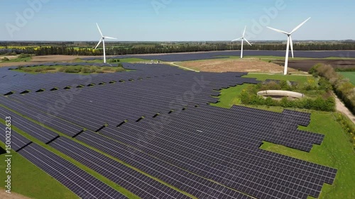 Drone view of Denmark’s largest solar farm in Kassø with wind turbines and green energy