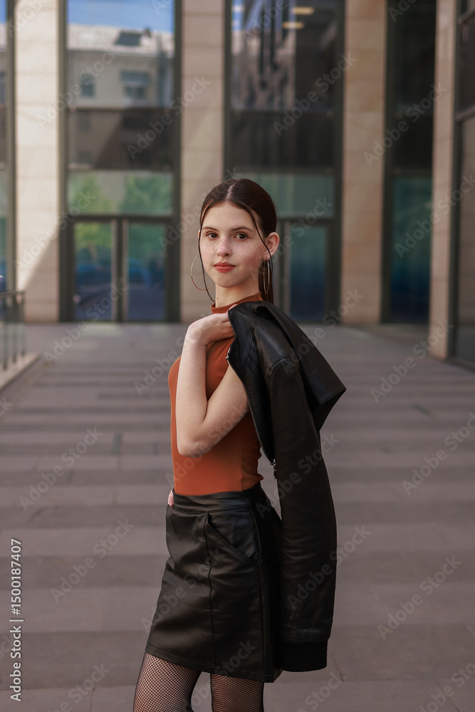 Obraz premium A girl walks through a modern city.