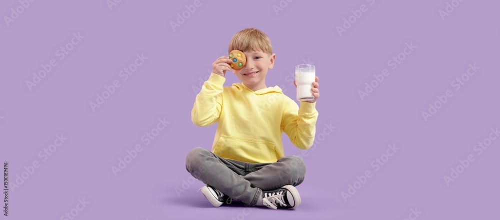 Little boy with glass of milk and cookie on lilac background Little boy with glass of milk and cookie on lilac background