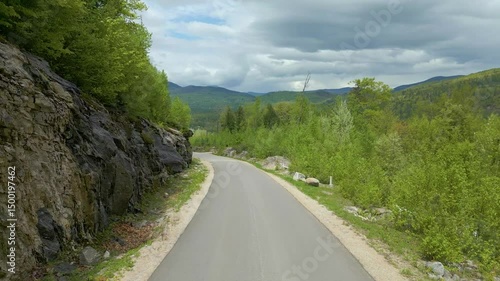 Winding Road Through Mountains Under Cloudy Sky in Maine, drone 4K