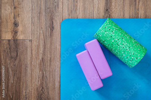 Mat and roller for Yoga or Pilates classes, flat layout with copies of health concepts and daily workouts to keep fit