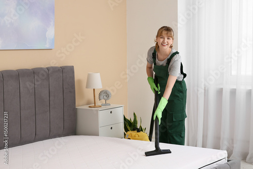 Female janitor cleaning mat...