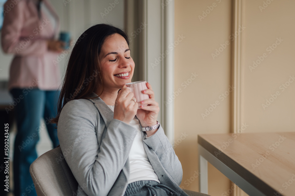 Businesswoman enjoying a relaxing coffee break at the office Businesswoman enjoying a relaxing coffee break at the office