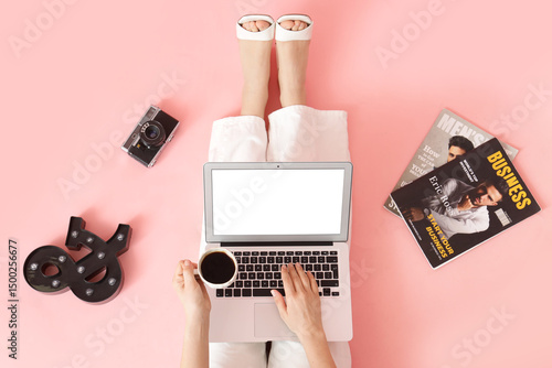 Woman using laptop with cof...