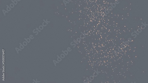 A dark gray background is subtly textured with a scattering of small, light orange specks concentrated towards the right side. The overall effect is understated and elegant.