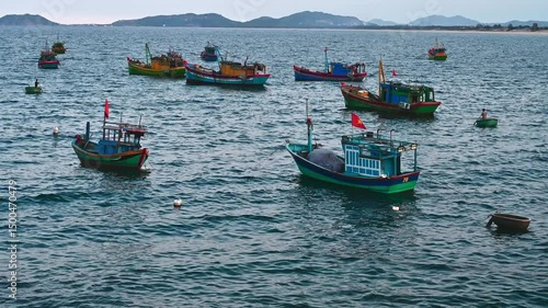 Traditional wooden Vietnamese fishing boats and ships at sea at the port in Vietnam