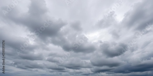 Thick, grey clouds dominate a vast, overcast sky, stratus, dark