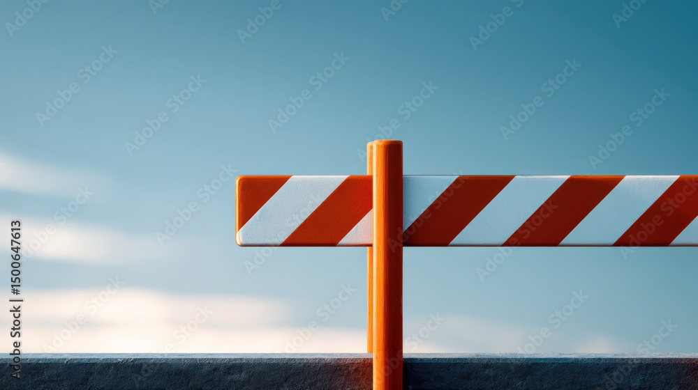 Safety barrier with orange and white stripes stands against blue sky, indicating restricted Safety barrier with orange and white stripes stands against blue sky, indicating restricted