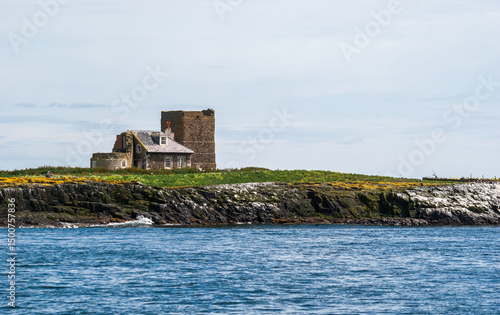 Keeper's cottage and remains of the two lighthouse towers on Brownsman Island in the Farne Islands, Northumberlandshire - UK