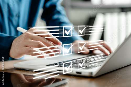 Businesswoman managing digital checklist on laptop with virtual tick boxes, planning and productivity concept, hand using stylus for project organization and efficient task management in modern office