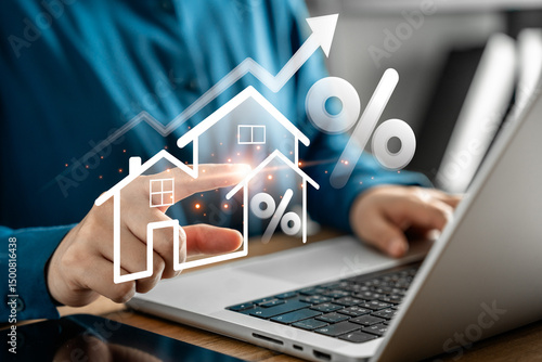Real estate investment and housing market analysis with digital interface, businessman's hand pointing virtual house and interest rate icon on laptop for property growth and mortgage trends.