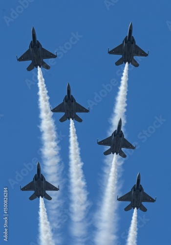Photo of Six Fighter Jets in Formation with White Smoke Trail Against Blue Sky