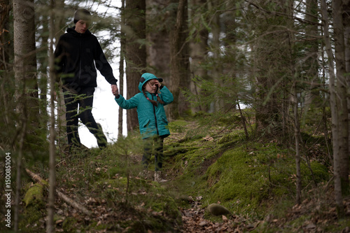 Wallpaper Mural Exploring the serene forest path as a child and adult bond over nature and adventure during a quiet, misty afternoon in the woods Torontodigital.ca
