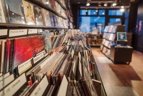 A close-up view of neatly organized vinyl records in a vintage-style music store. The records are categorized with labeled dividers, creating an inviting and nostalgic atmosphere. 