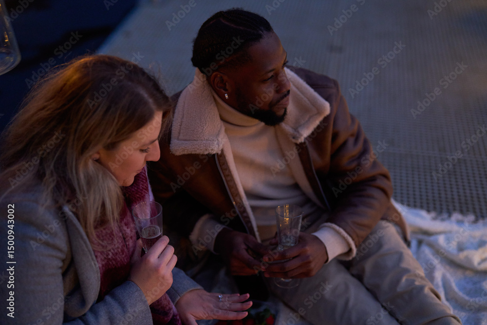 Couple enjoying champagne on pier at dusk Couple enjoying champagne on pier at dusk
