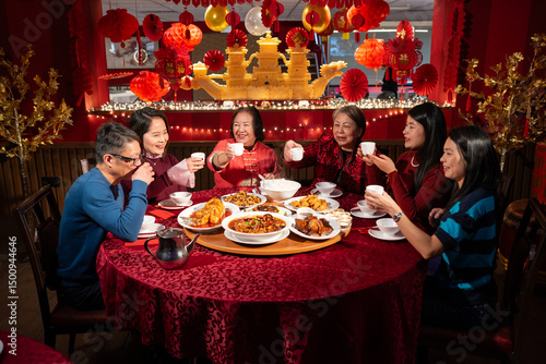 Smiling family enjoying Chinese New Year dinner in restaurant