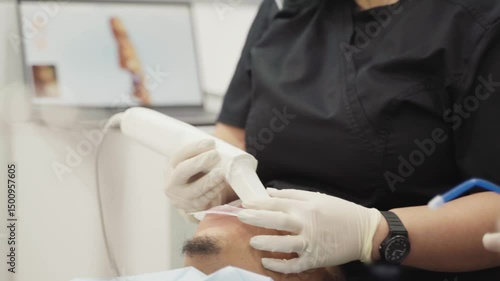 Dentist using 3d scanner for dental impression on patient